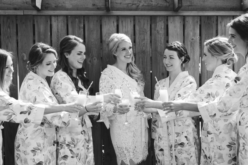 bride and bridesmaids having mimosas