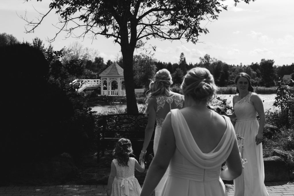 bride and bridesmaids walking in black and white