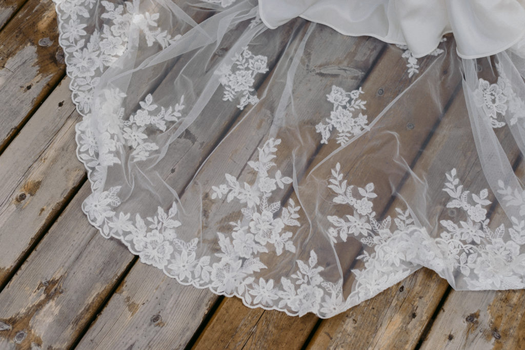 lace train on wood of stella york wedding dress
