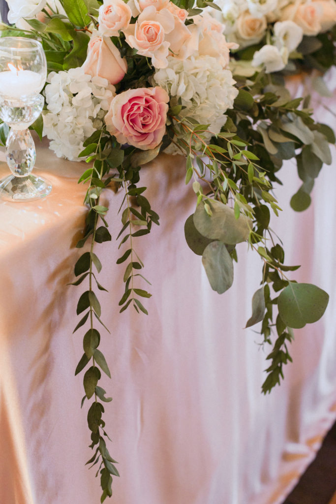 blush table cloth with florals on head table