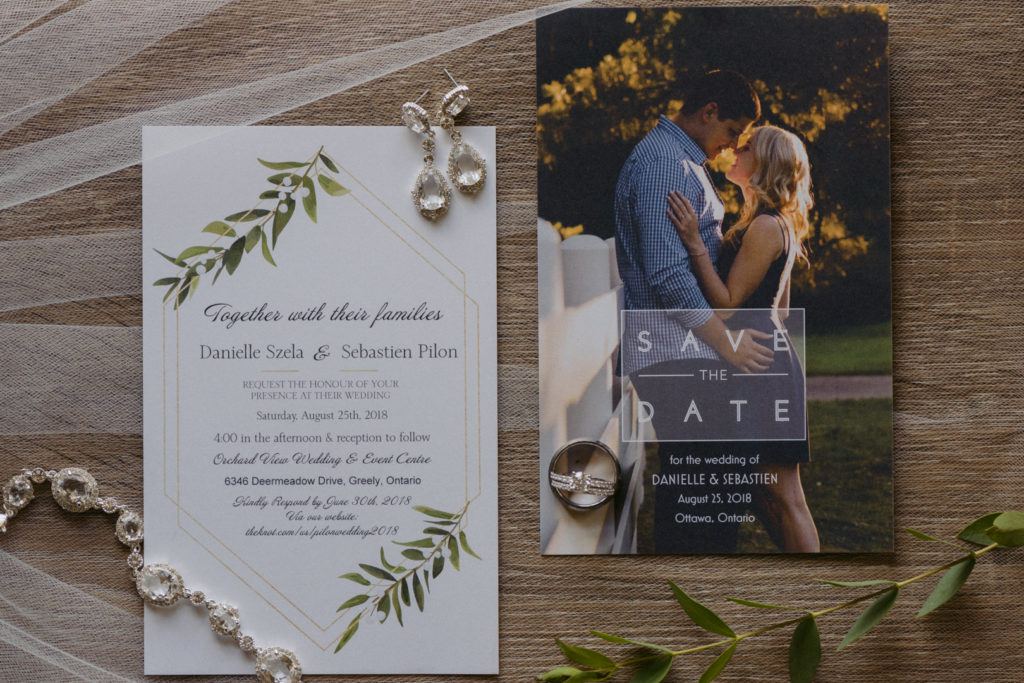 flat lay of wedding invitation and bridal jewellery