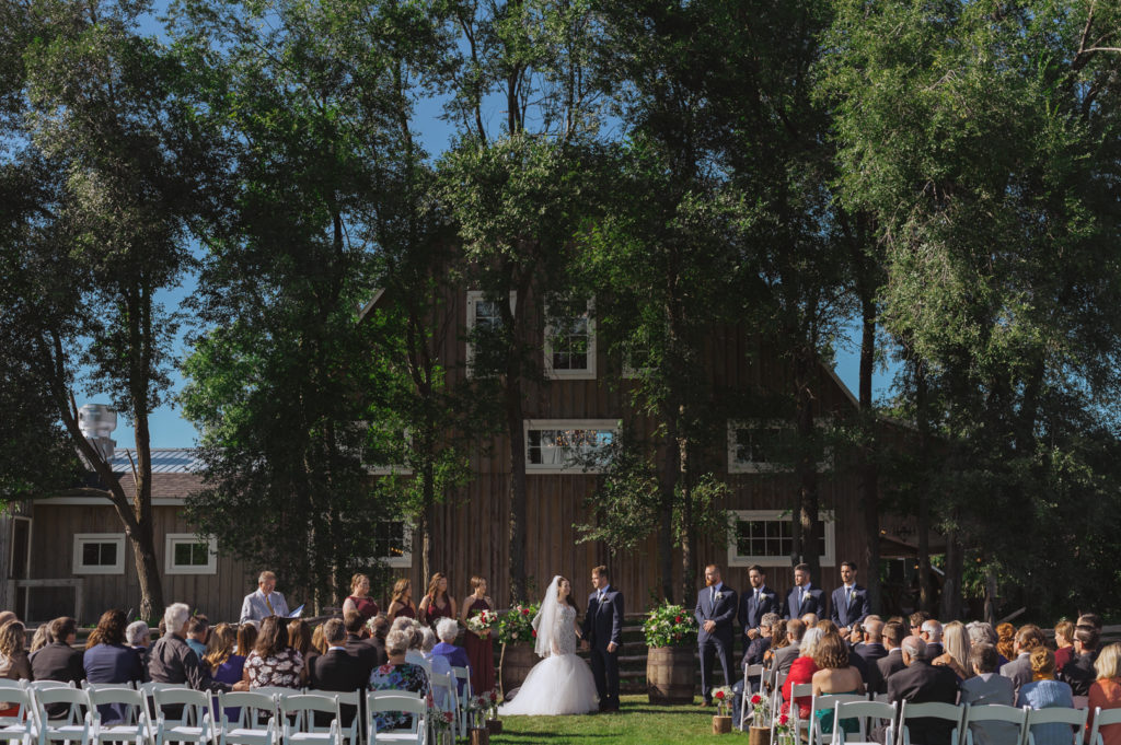 wedding ceremony in front of Stonefield Barn