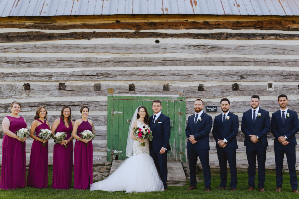 wedding party in front of barn