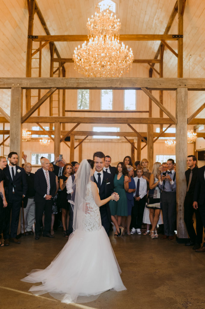 bride and groom first dance at stonefields while guests surround them