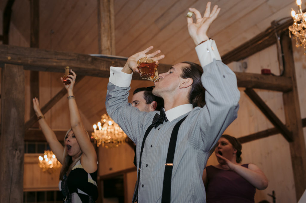 wedding guest chugging bottle of maple syrup