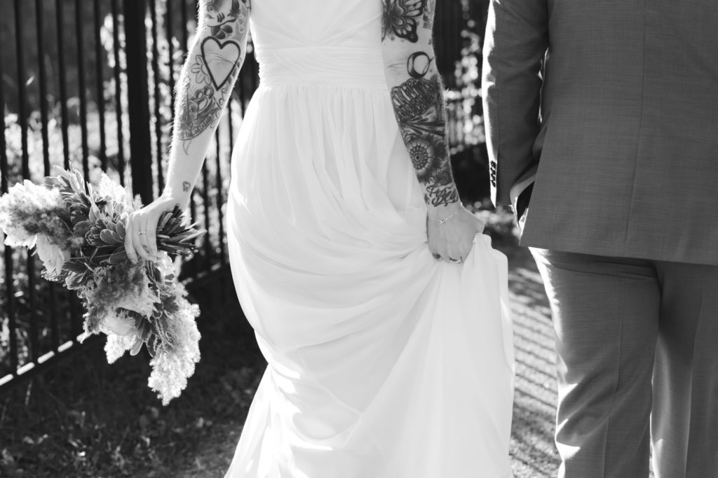 tattooed bride and groom walking together