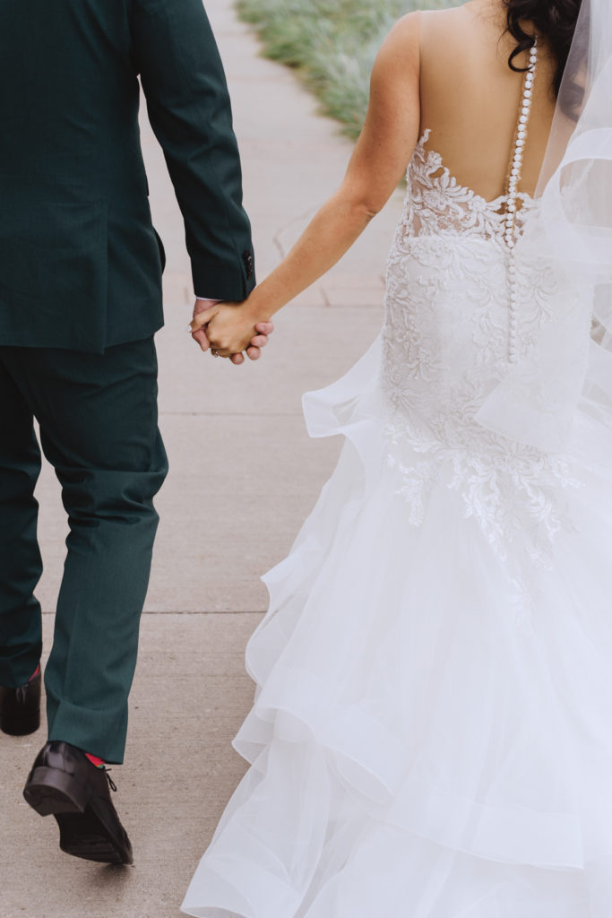 bride and groom holding hands walking