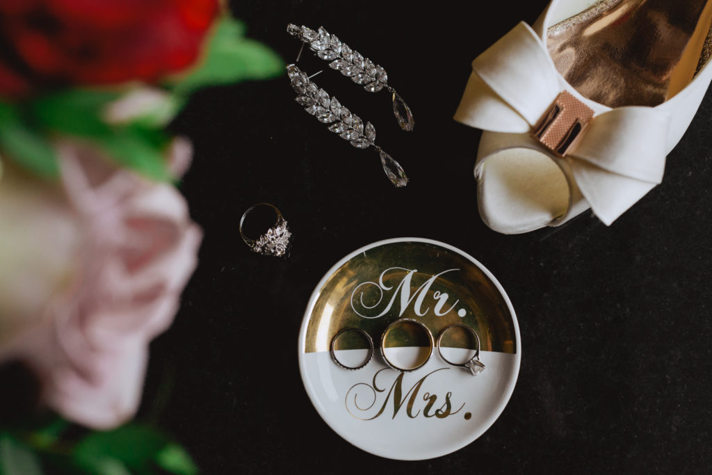 wedding jewellery and and accessories flat lay on black table