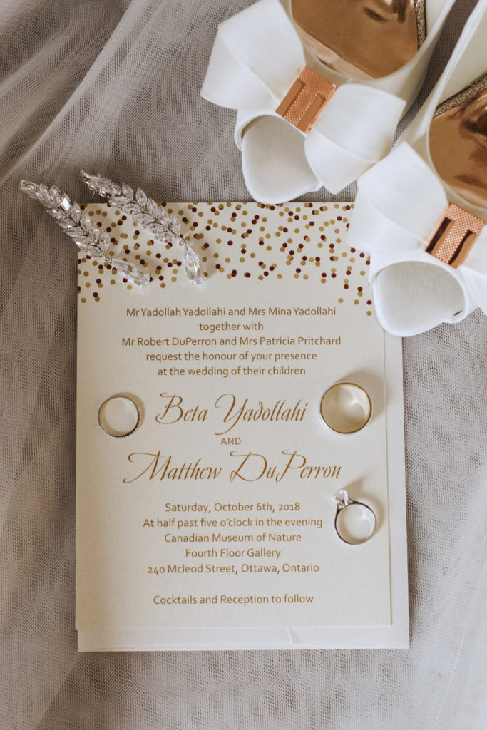 wedding invitation suite and rings flat lay