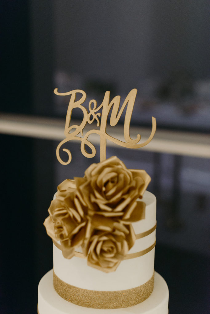 gold cake topper with bride and groom's initials