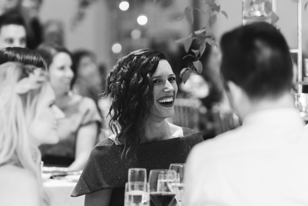 wedding guest laughing during speeches