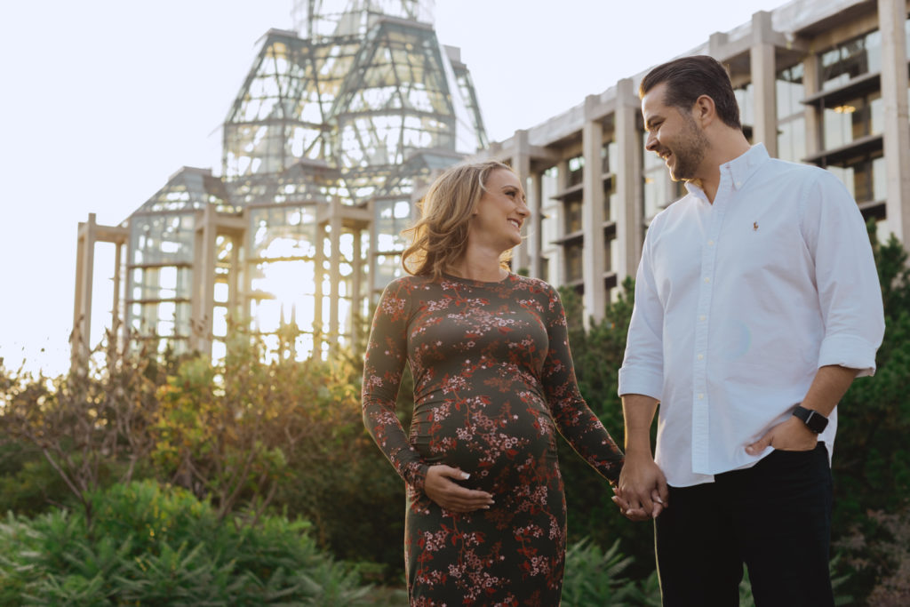 parents to be smiling at each other at sunset