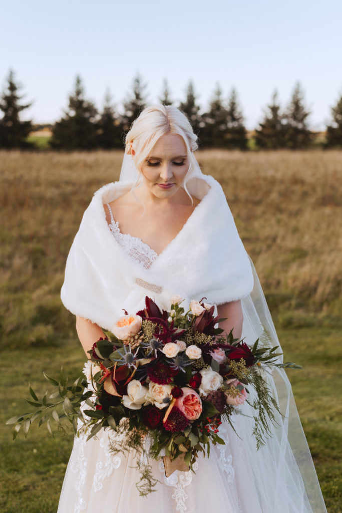 bride in a field at sunset