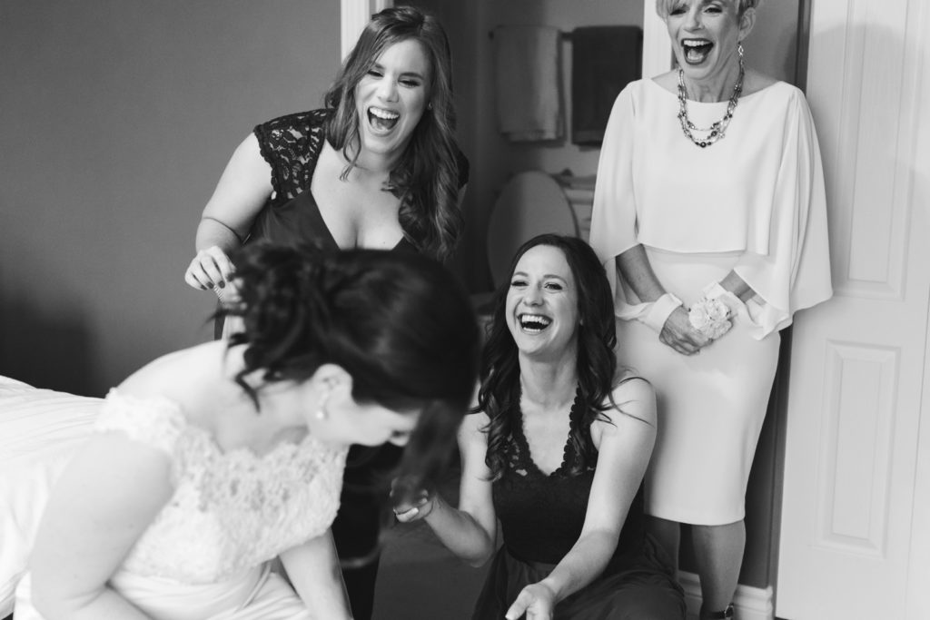 bridesmaids and mother of the bride laughing