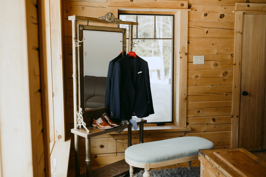 groom's suit jacket hanging from dresser