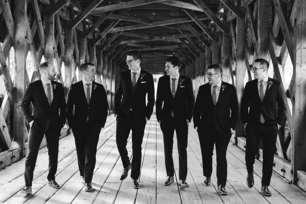 groom and groomsmen walking on the Wakefield covered bridge