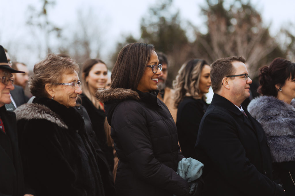 wedding guests smiling during outdoor wedding ceremony