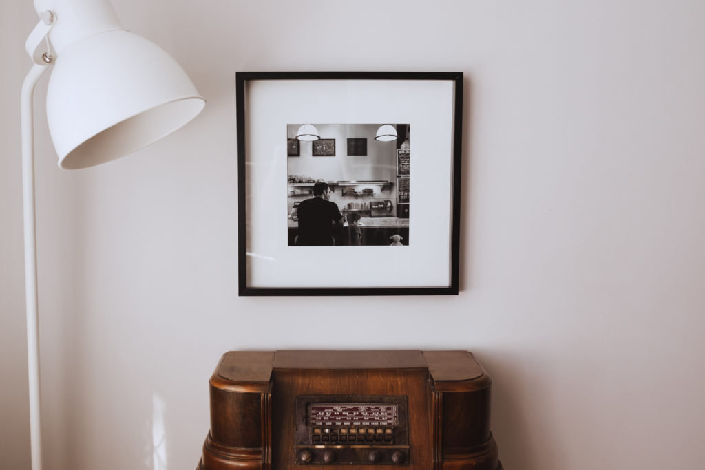 framed photo of family above vintage radio