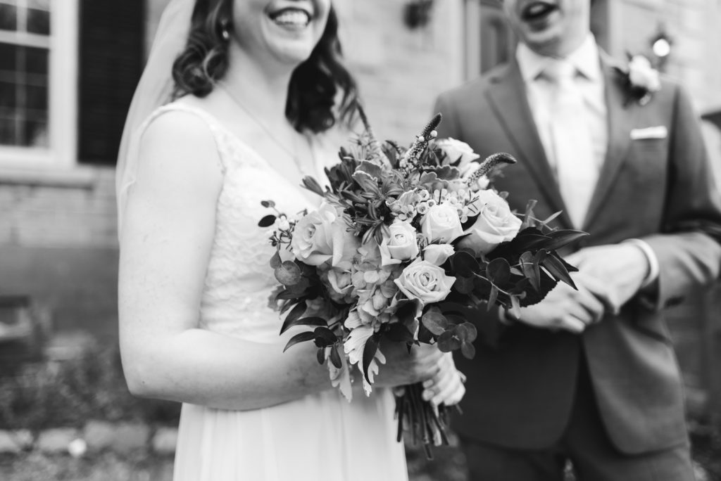 bride holding bouquet laughing