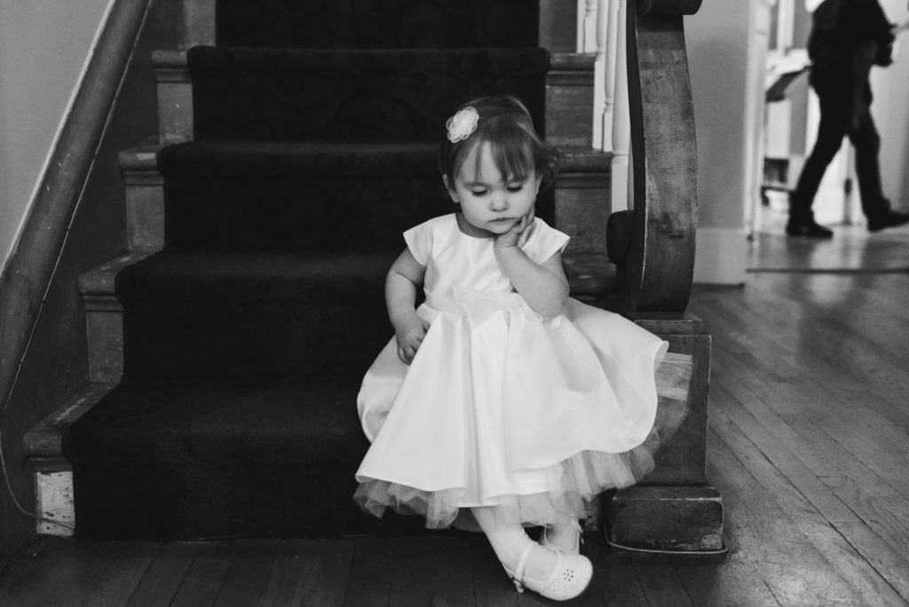 flower girl sitting on the stairs