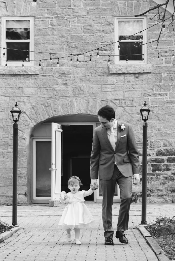 Groom and daughter walking down the aisle together