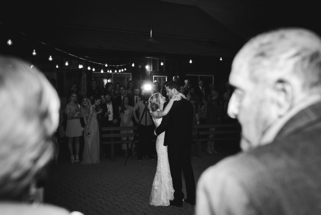 bride and groom first dance outdoors under twinkly lights