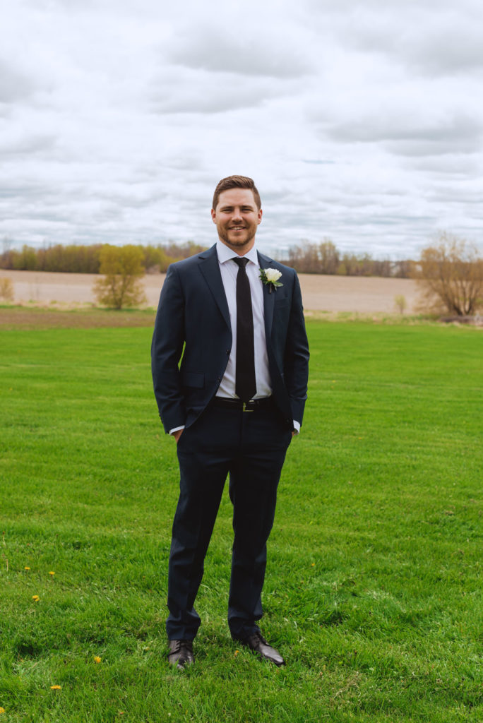 groomsmen smiling in the fields of Strathmere