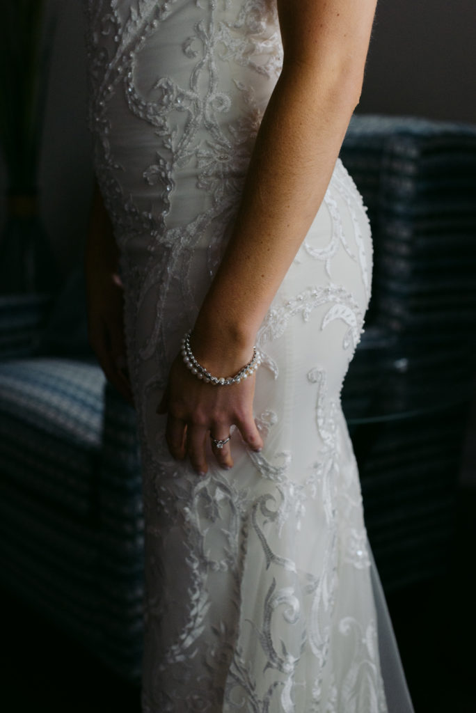 lace details of bride's dress and pear bracelet