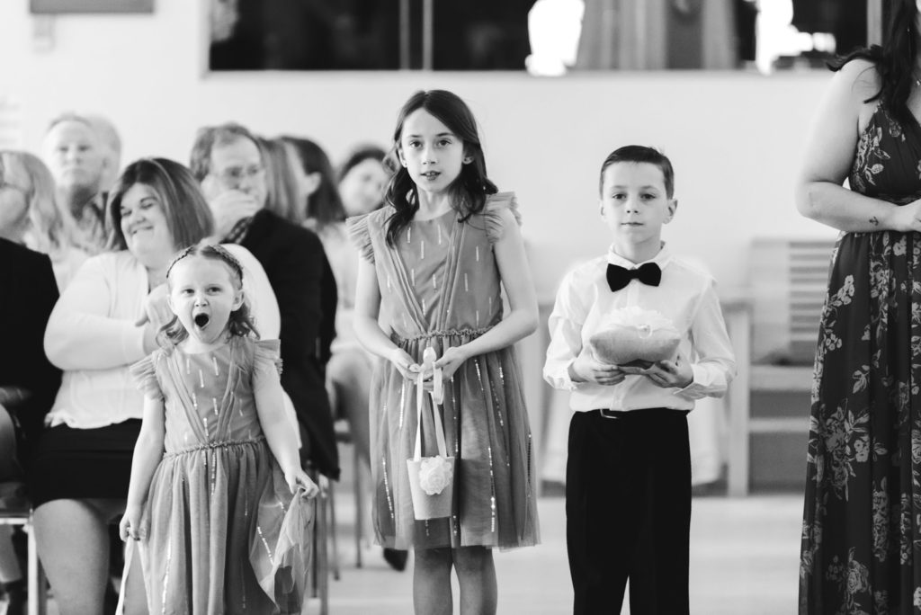 flower girl and ring bearer waiting at the end of the aisle