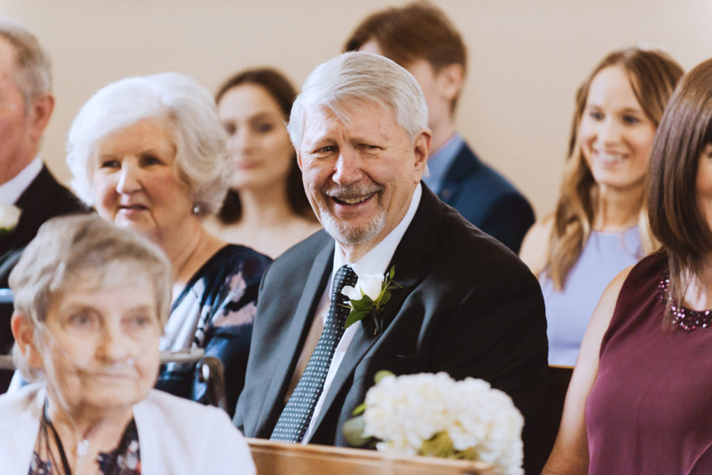 wedding guest laughing during ceremony
