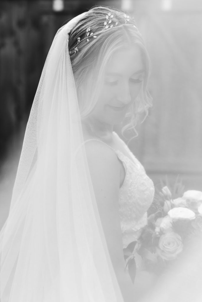 black and white photo with veil blowing in the wind