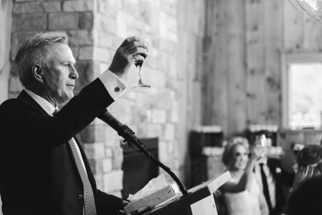 father of the bride giving a toast during his speech at wedding reception