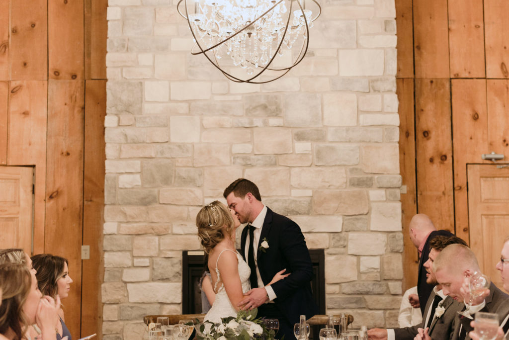 bride and groom kissing during wedding reception