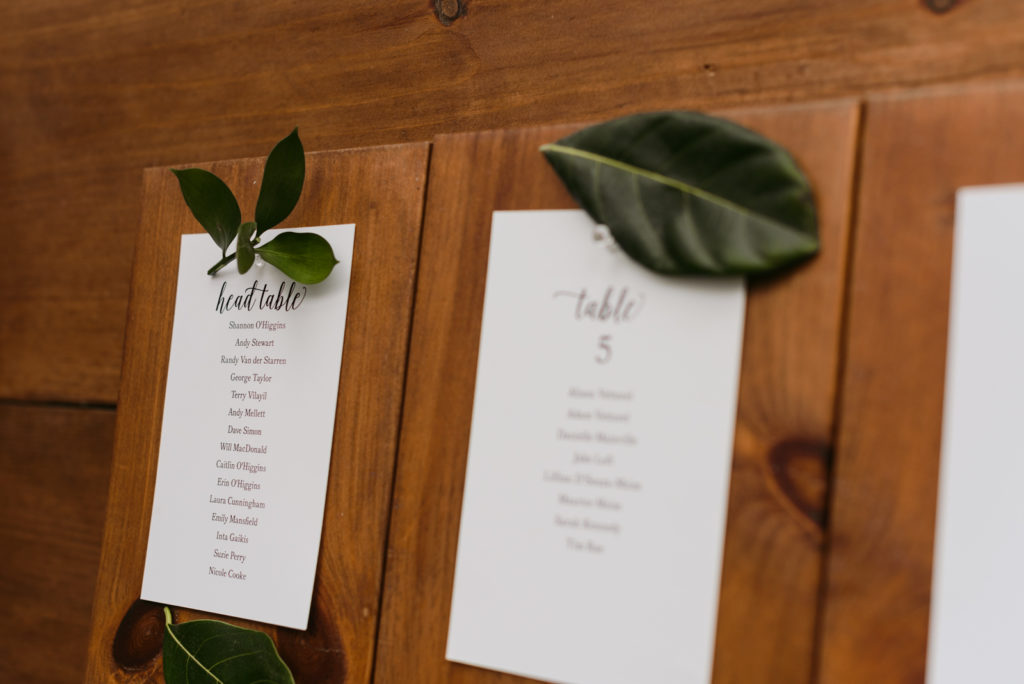 seating chart with leaves on wooden plank
