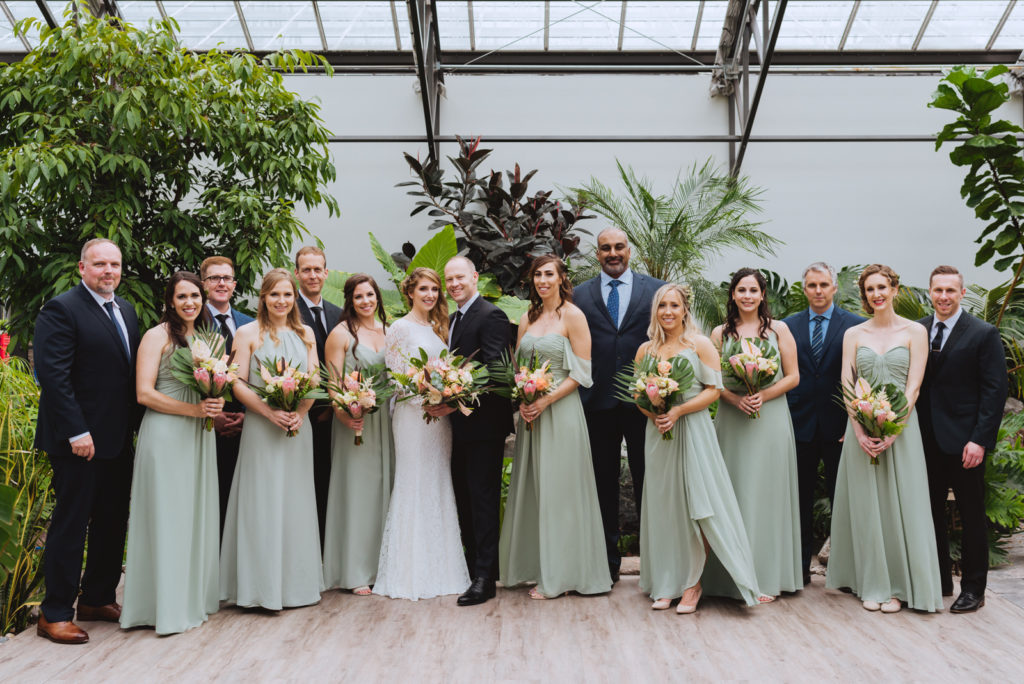 sage green bridesmaids dresses with boho bouquets in greenhouse