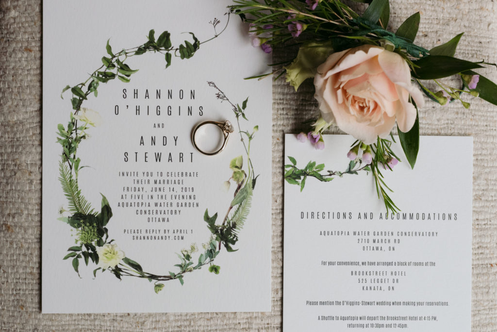 wedding invitation with engagement ring and boutonniere