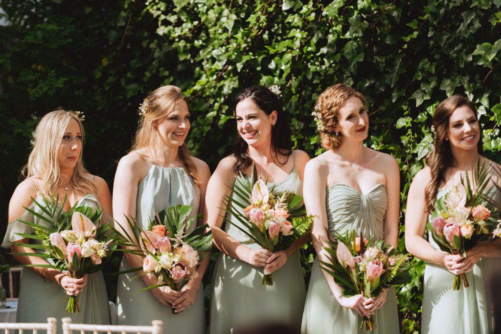 bridesmaids laughing during wedding ceremony