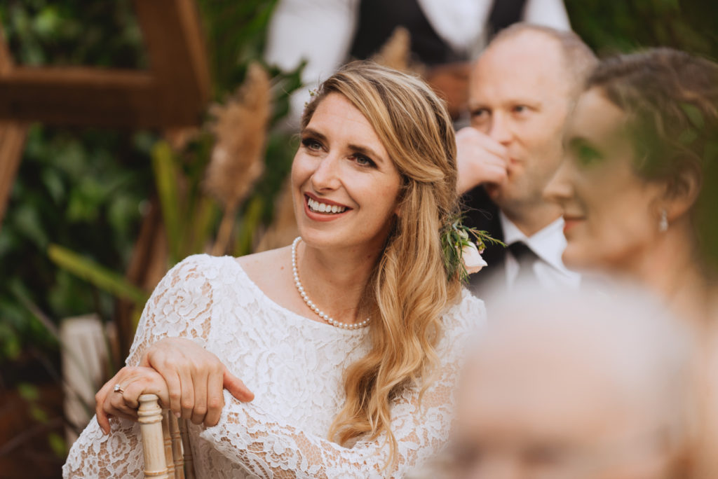 bride smiling during wedding reception speeches