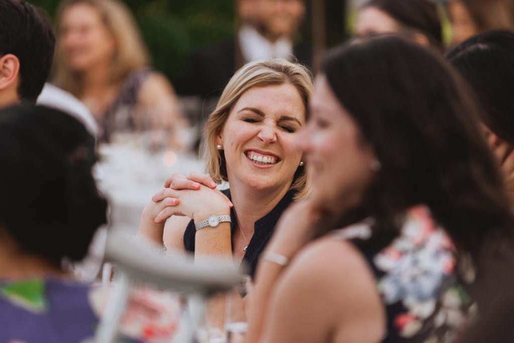 guest laughing during wedding speeches