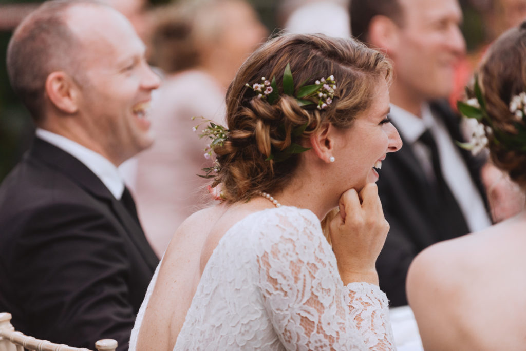 bride smiling during wedding reception speeches