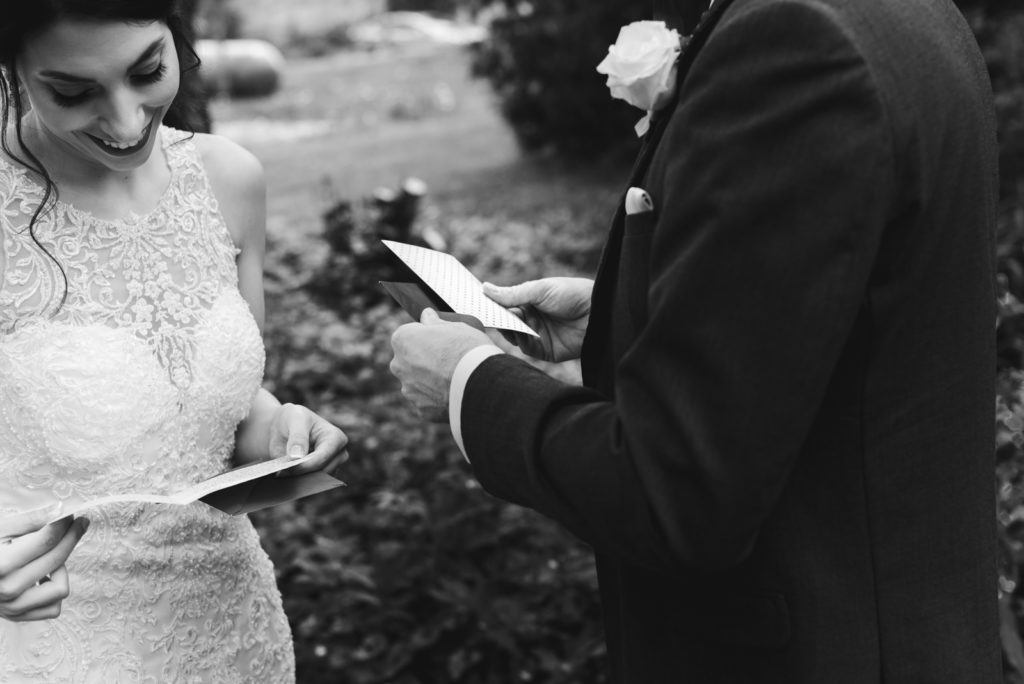 bride and groom exchanging cards from one another