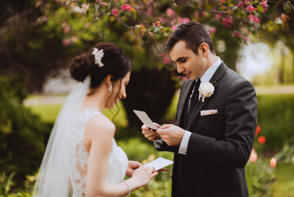 bride and groom reading letters from one another