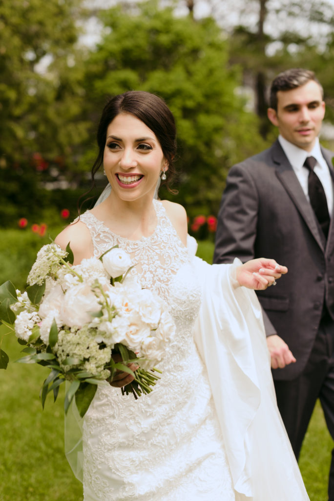 bride and groom walking holding bouquet