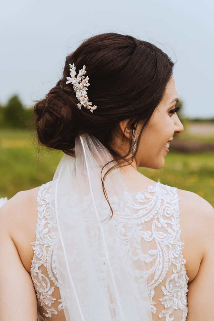 bride looking over her shoulder in a field