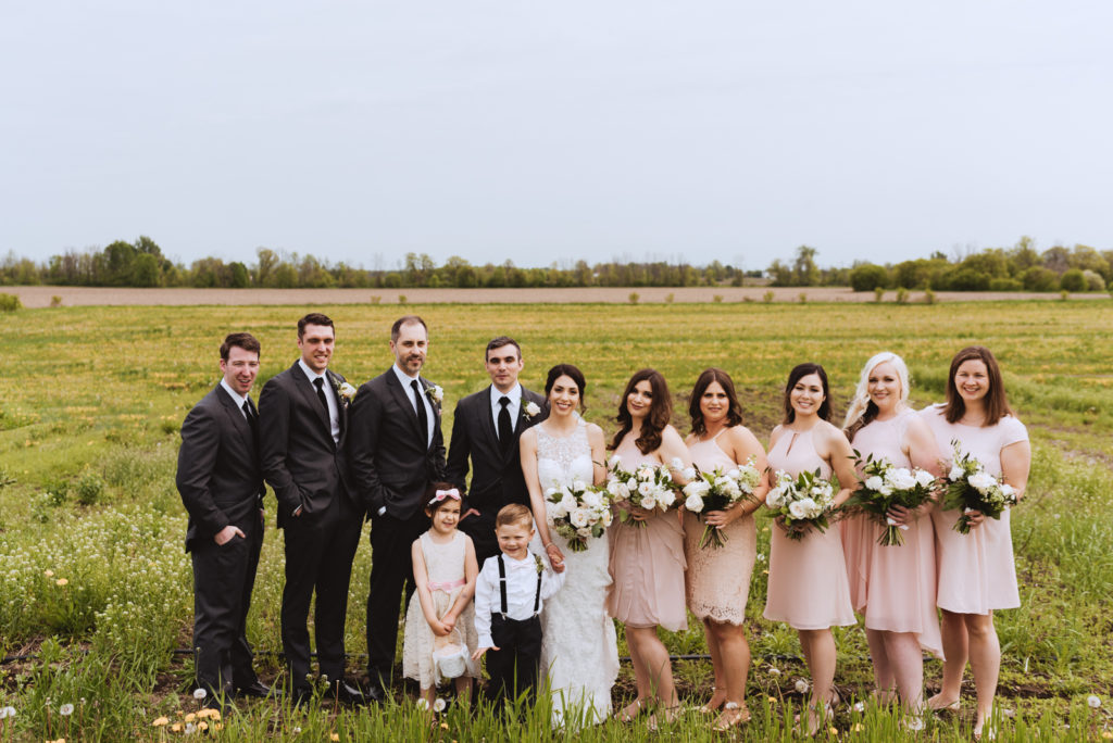 wedding party in a field of yellow dandelions