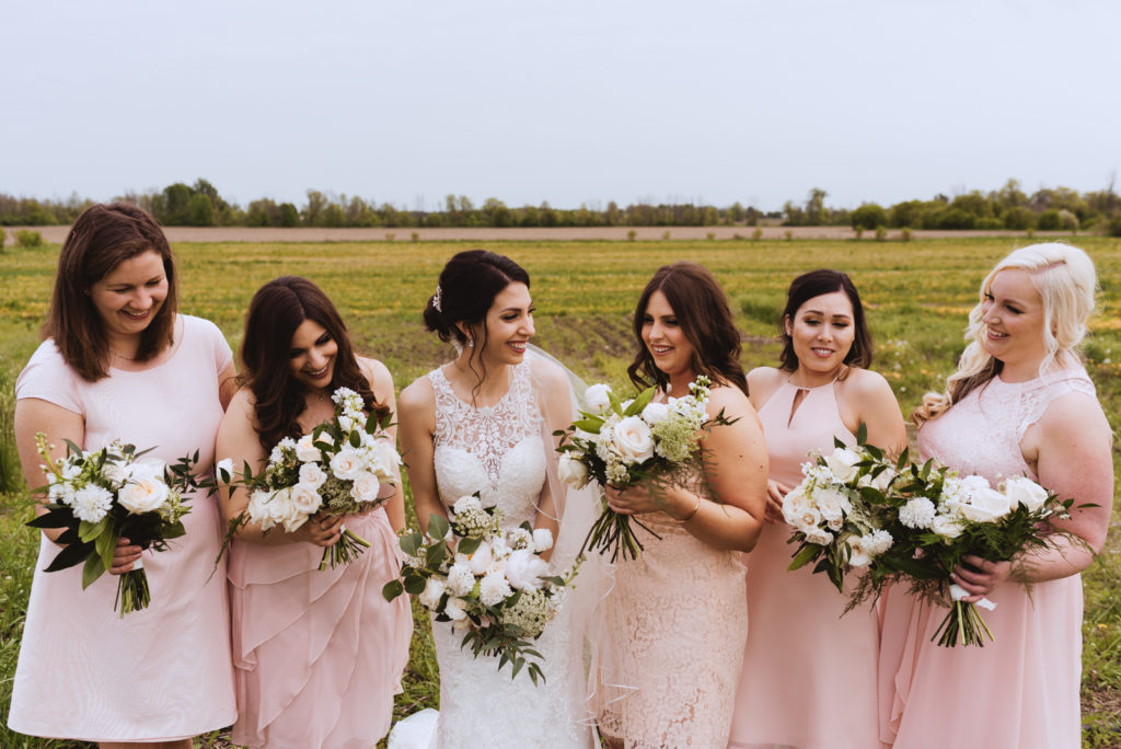 bride and bridesmaids in a field
