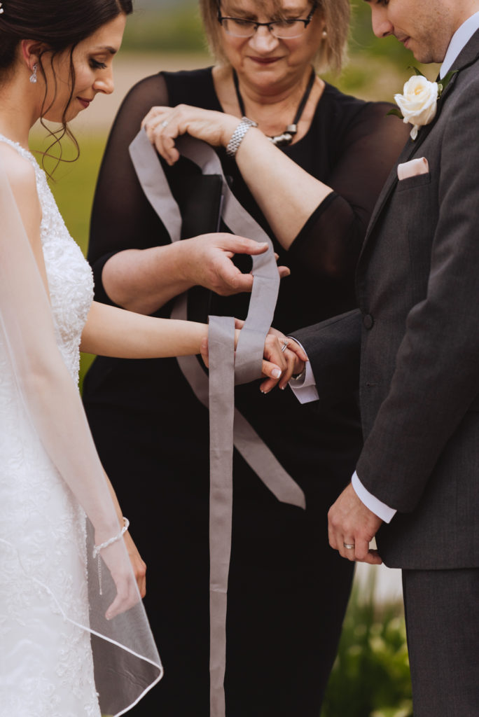 bride and groom hand tying ceremony