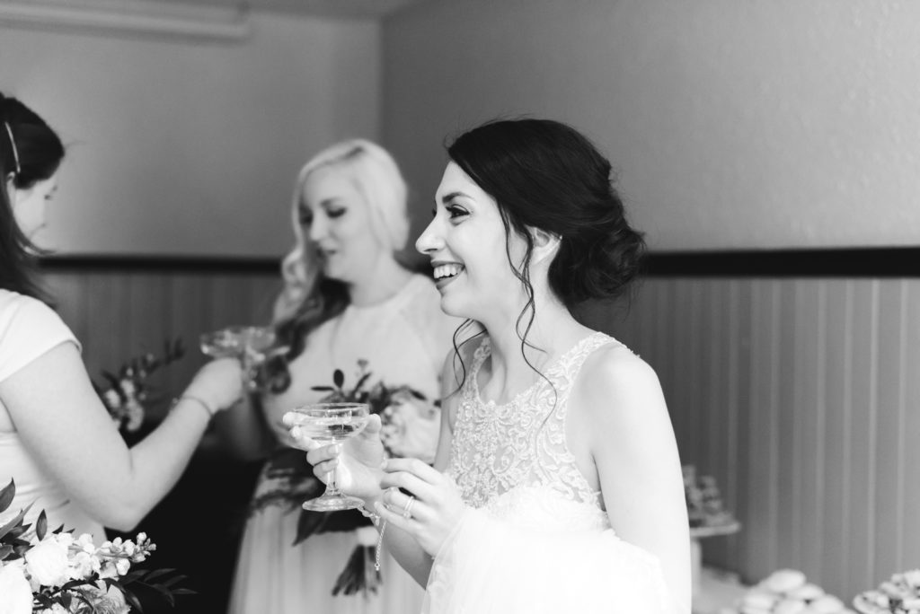 bride holding a glass of champagne after ceremony