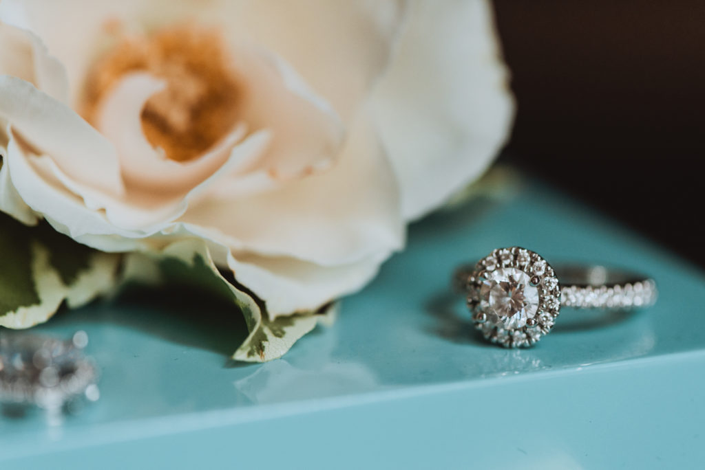 engagement ring on blue box with flower