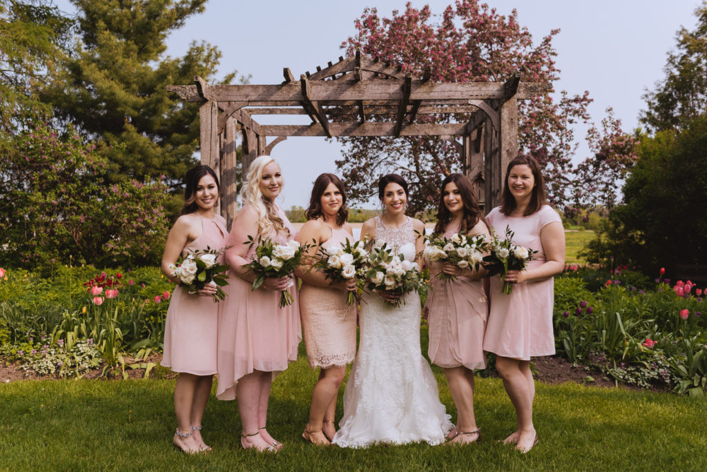 bride and bridesmaids in the garden at Strathmere in Ottawa